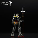 MechaNaka's Gunpla weapon - A miniature jumonji yari / jumonji spear. A jumonji yari is a traditional Japanese cross-shaped spear. It became a very iconic weapon used by Sanada Yukimura, a Sengoku period samurai often praised as "The Best Soldier of Japan".